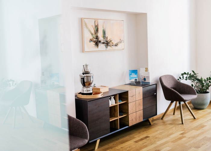Wartebereich der Praxis Alma Fluente mit Sessel und Teestation